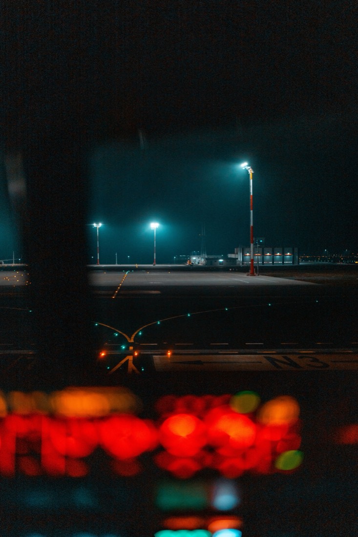 Taxiway centreline and stop bar lighting seen from a vehicle at night